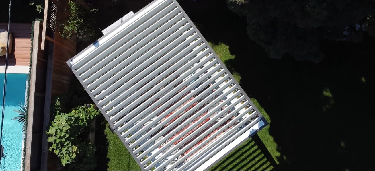 Aerial view of a louvered roof structure over a residential terrace