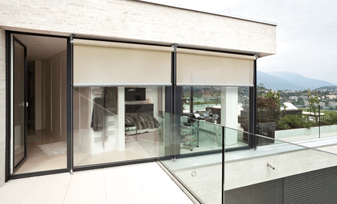 Cable guided motorized shade screen on modern glass facade