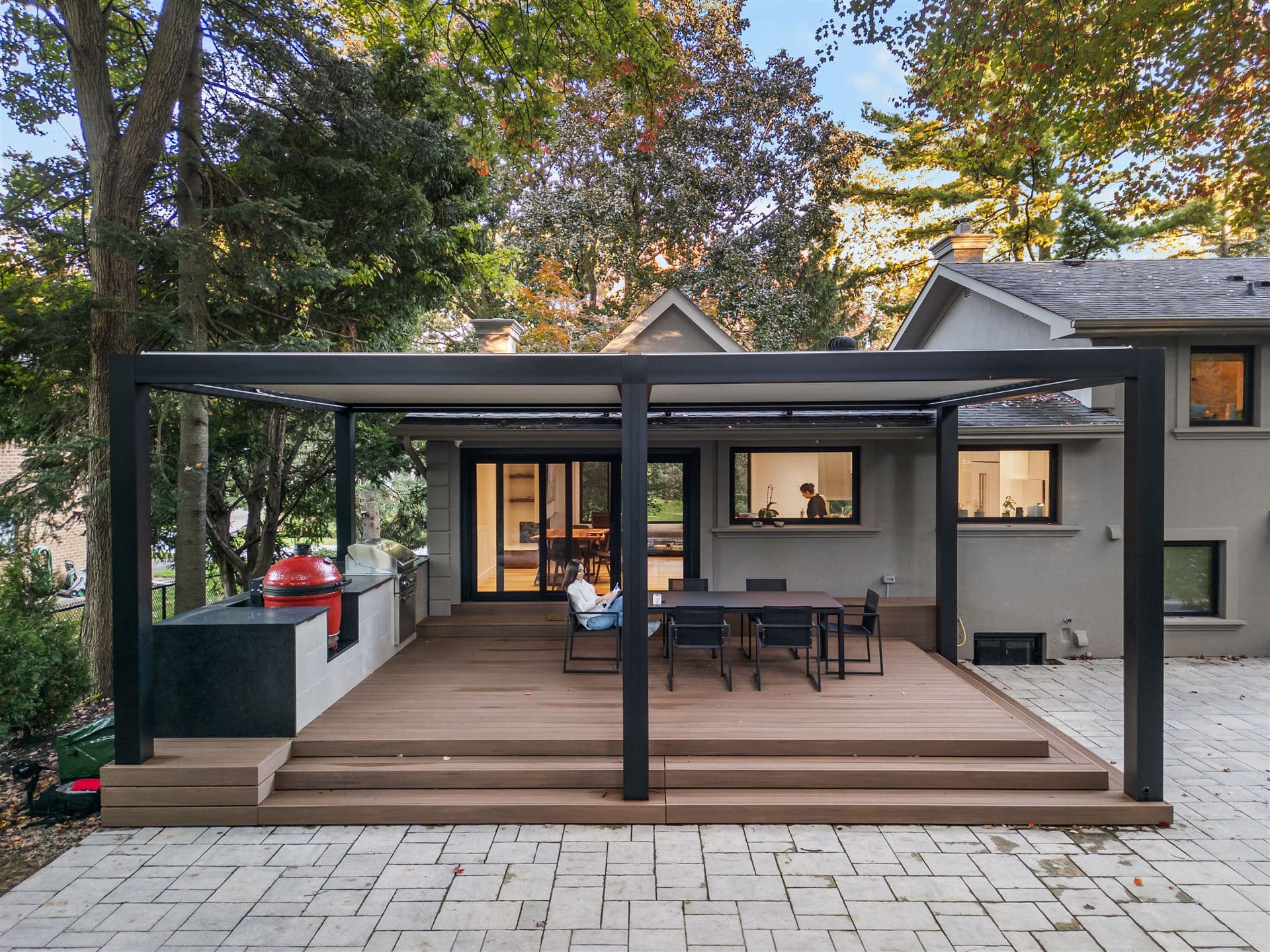 LOUSOL attached louvered pergola over a deck with outdoor kitchen