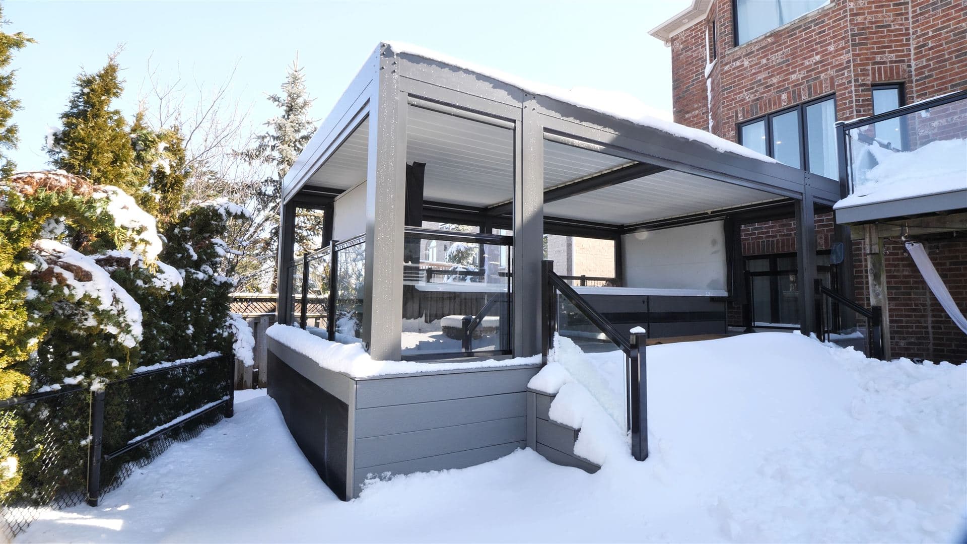 LOUSOL louvered pergola in winter carrying snow