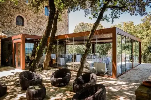 Enclosed restaurant patio with retractable roof and glass walls